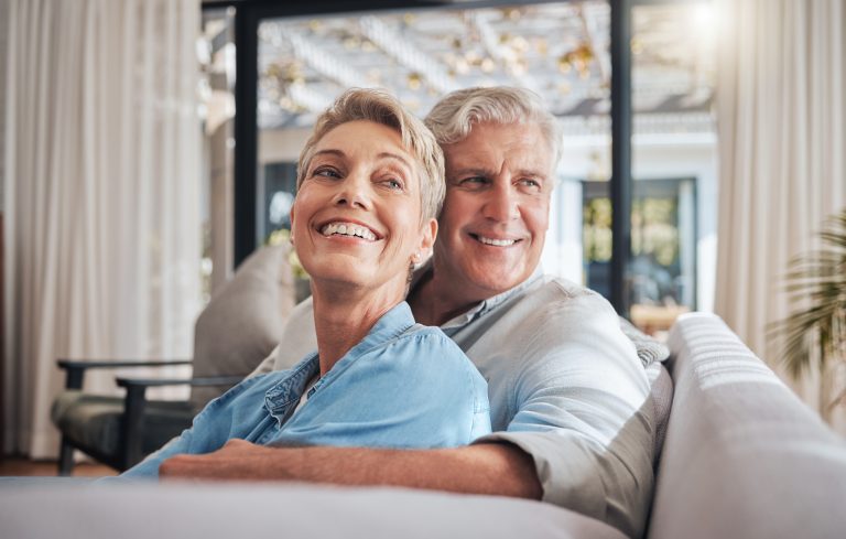 Love, couple and retirement with a senior woman and man on a sofa to relax in their home together.